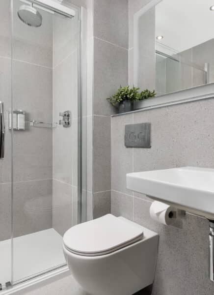 A modern, fully-equipped studio apartment featuring a comfortable bed, open-plan kitchen, stylish furnishings, large windows, and a cozy ambiance perfect for short or extended stays.